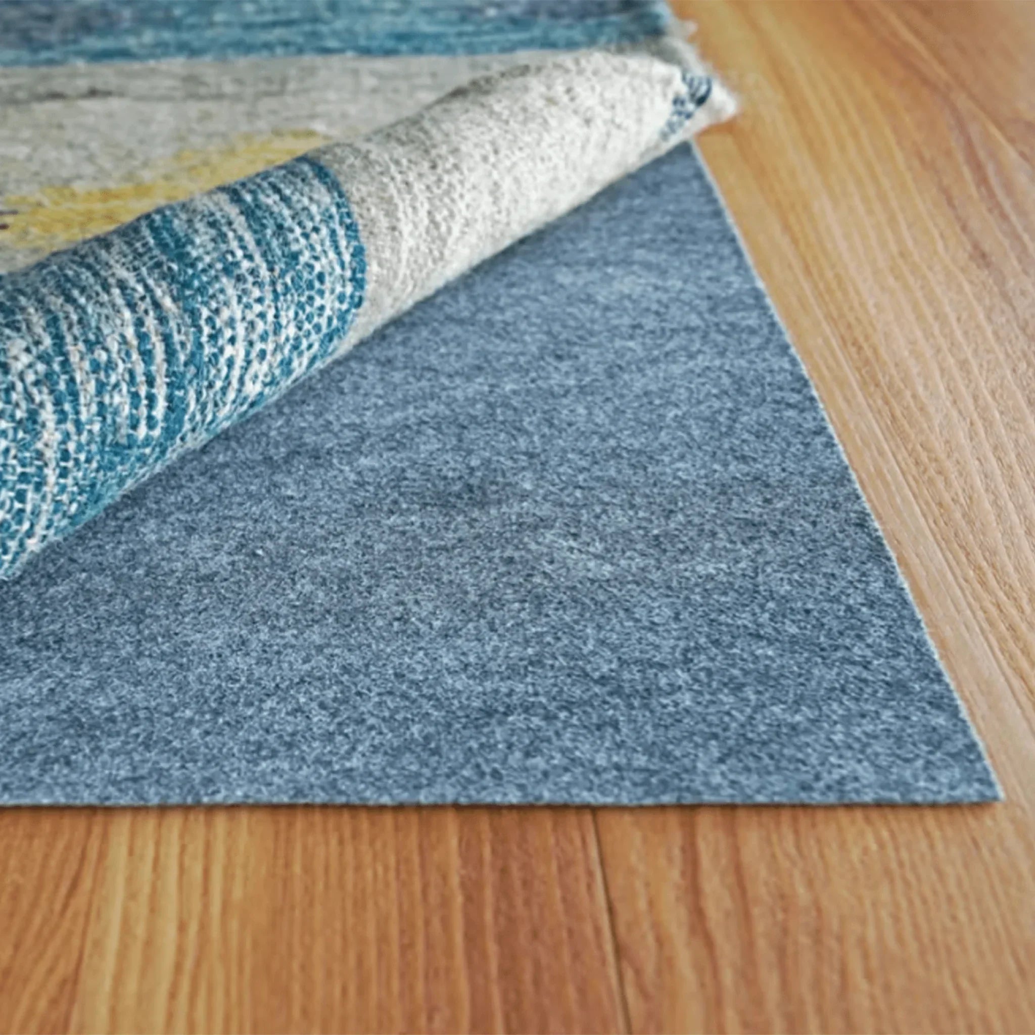 Roll of blue carpet padding on a wooden floor