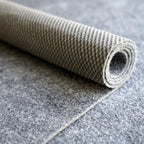 Rolled-up carpet on a tiled floor