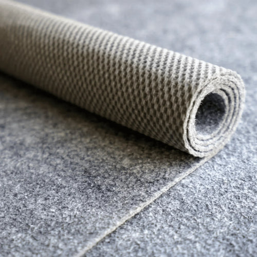 Rolled-up carpet on a tiled floor